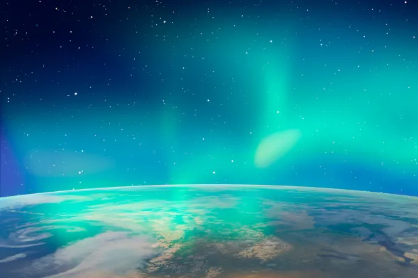 Fotografia da aurora boreal, fenômeno que ocorre na termosfera. Trata-se de uma luz no céu, ela difusa na cor verde florescente.