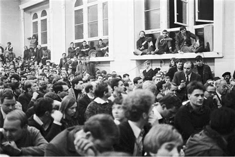Fotografia em preto e branco, mostrando várias pessoas ocupando a via pública, retrato da revolução social.